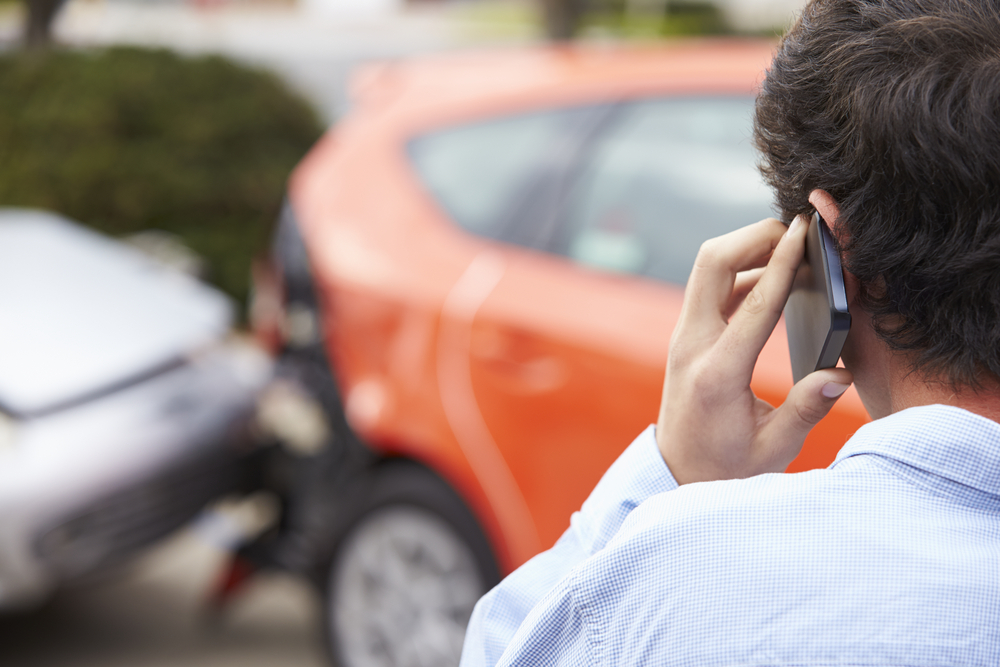 Photo of a Man on the Phone after Accident